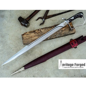 May include: A silver and black sword with a leather sheath. The sword has a curved blade and a black handle. The sheath is burgundy with red leather accents. The image also shows a hammer, pliers, and the text "Aeritage Forged".