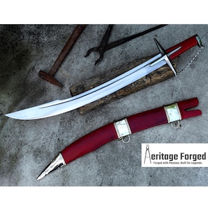 May include: A curved sword with a silver blade and a red handle and sheath. The sword has a cross-shaped guard and a chain attached to the handle. The sheath has silver accents. The text "Aeritage Forged" is visible.