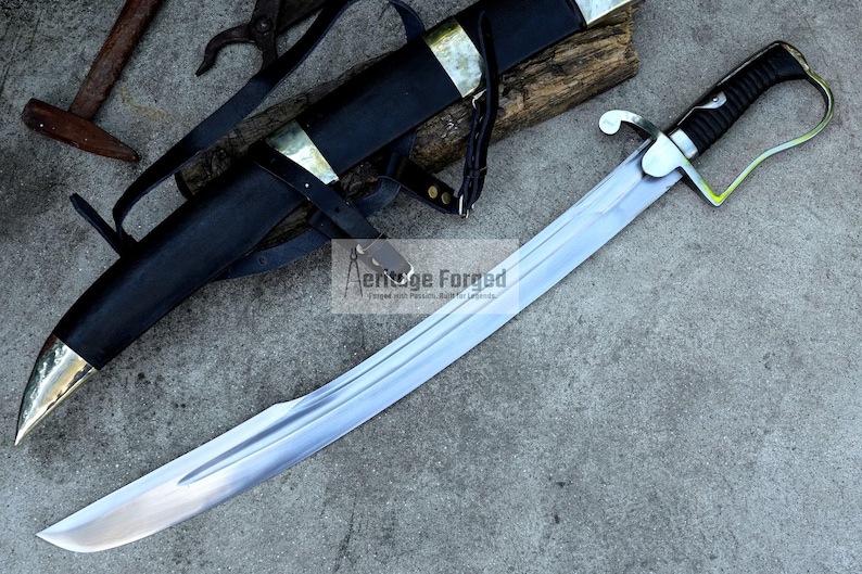 May include: A curved, silver-bladed sword with a black handle and guard, resting on a gray surface. The sword is accompanied by a black sheath with brass accents and leather straps. The text "Aenuge Forged" is visible.