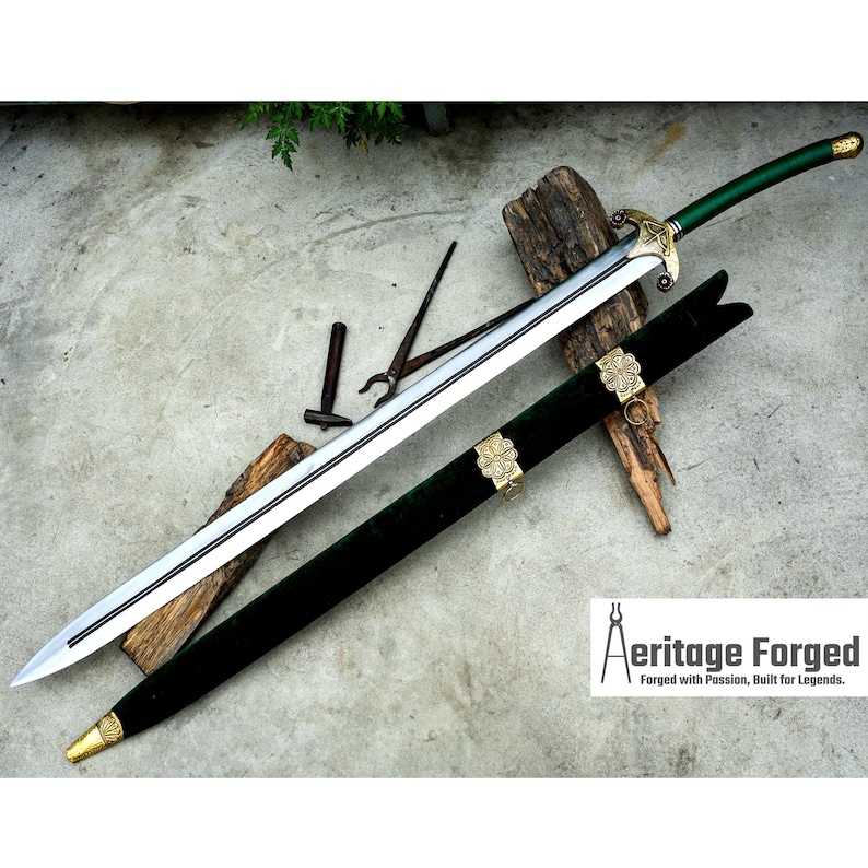 May include: A long, silver sword with a green handle and a matching green sheath. The sheath is adorned with gold-colored clasps. The sword rests on a wooden surface, with the text "Aeritage Forged" visible in the lower right corner.