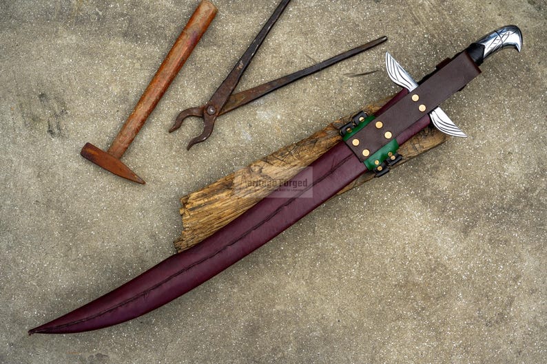May include: A handcrafted sword with a burgundy blade and a brown leather sheath, accented with green and gold details. A hammer and pliers are visible in the background, suggesting a blacksmithing theme.
