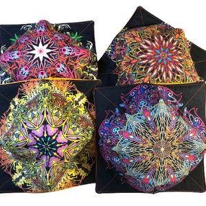 May include: Four black square throw pillows with colorful mandala designs. The pillows have a black background with a yellow, orange, pink, blue, and green mandala pattern.