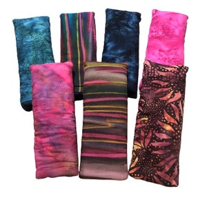 May include: A set of eight eye pillows in various colors and patterns. The pillows are made of fabric and filled with rice and lavender. They are designed to be used for relaxation and stress relief.