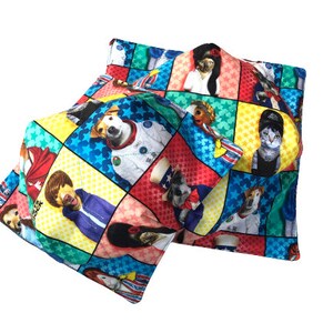 May include: Two colorful square pillows with a patchwork design featuring various animals dressed in different outfits. The pillows are made of a soft, comfortable fabric and feature a variety of colors, including red, blue, green, yellow, and white.