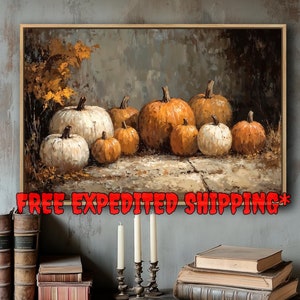 May include: A framed painting depicts a collection of pumpkins in various sizes and shades of orange and white. The artwork has a rustic, autumnal theme. The text "FREE EXPEDITED SHIPPING" is displayed across the bottom of the painting.