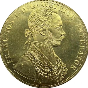 Puede incluir: Moneda de oro con un retrato de perfil de un hombre barbudo con una corona. La moneda tiene la inscripción "D.G. AVSTRIAE IMP.  FRATR.  IOR." alrededor del borde.
