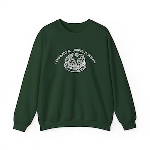 May include: A dark green sweatshirt with the text "I earned a waffle party" and a white outline of a waffle with a star on top.