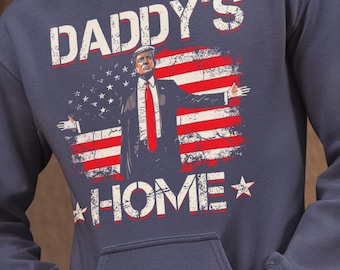 May include: A navy blue hoodie with a distressed American flag design featuring a man in a suit and tie. The text "Daddy's Home" is printed on the hoodie.