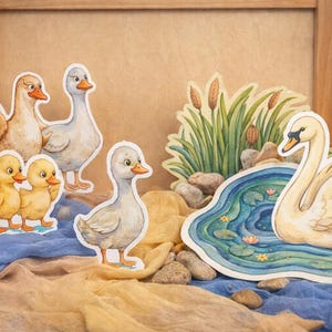 May include: A set of three ceramic mugs with a speckled, matte finish. The mugs are in cream, light grey, and dark grey. Each mug has a simple, minimalist design, ideal for coffee or tea.