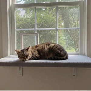 May include: A rustic wooden sign with the text "Welcome to our home" in white lettering. The sign features a distressed finish and a simple, inviting design, perfect for entryway decor.