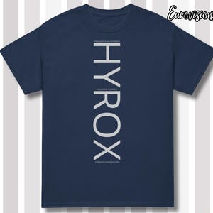 May include: A navy blue short-sleeve t-shirt featuring the vertical white text HYROX in the center. Smaller white text above and below the main word reads STRONGER THAN YESTERDAY, CHALLENGE YOURSELF, and STRENGTH OVER EXCUSES. The top right corner displays the text EurovisionArt.