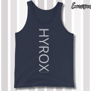 May include: A navy blue tank top featuring the vertical white text HYROX centered on the chest. Smaller white text is positioned above and below the main word, reading CHALLENGE YOUR YESTERDAY, CHALLENGE YOURSELF, and STRENGTH HAPPENS HERE.
