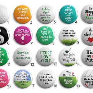 May include: Twenty golf ball-themed button pins with various sayings and designs. The buttons are white with black, green, red, pink, orange, and blue accents. Some of the sayings include "Peace Love and Birdies", "Keep Calm and Golf On", "Born to Golf, Forced to Work", "Do What You", "Kiss My Putt", and "Life is Full of Important Choices".