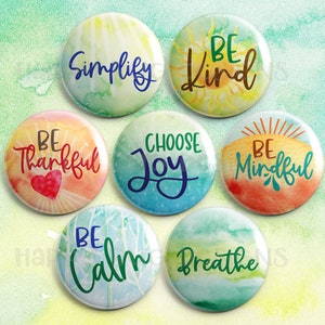 May include: Set of eight 1.5 inch round buttons with watercolor backgrounds and inspirational messages. The messages are "Be Kind", "Be Thankful", "Be Mindful", "Be Calm", "Choose Joy", "Simplify", "Breathe", and "Be Thankful".