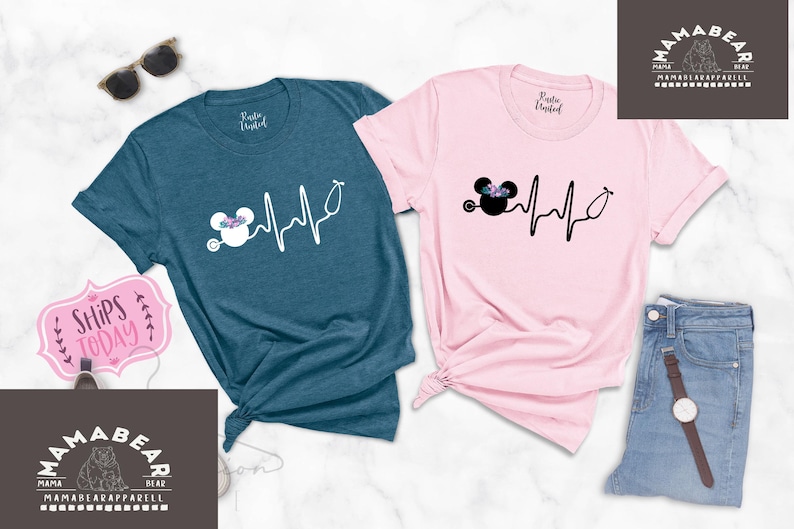 May include: Two t-shirts featuring a black and white graphic of a cartoon mouse with a stethoscope and a heartbeat line. The t-shirts are teal and pink.