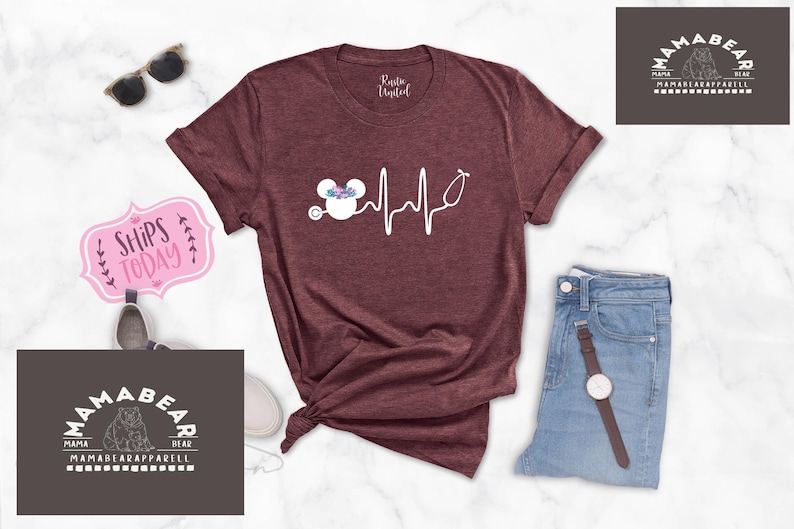 May include: A maroon t-shirt with a white graphic of a Mickey Mouse head with a floral crown and a stethoscope, with a heartbeat line and the text "Ships Today".