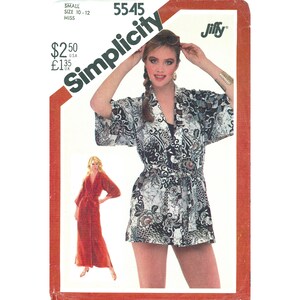 May include: Simplicity sewing pattern 5545 for a short robe with a tie waist and a long robe, featuring a black and white floral batik-style print. The envelope displays the pattern number, brand name, and size 10-12 small miss sizing information.