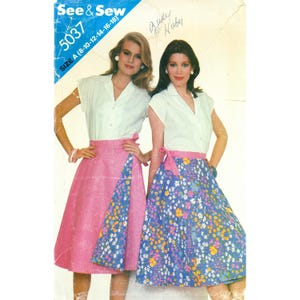 May include: See & Sew 5037 sewing pattern envelope featuring two variations of a wrap skirt and a short-sleeved collared blouse. One skirt is solid pink with a floral panel, the other is floral with a pink waistband. Size A 8-10-12-14-16-18.