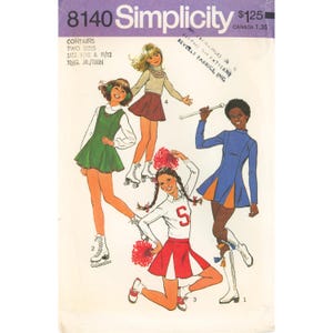 May include: A vintage Simplicity 8140 sewing pattern envelope for young junior and teen clothing. The cover features illustrations of four outfits: a green jumper, a beige turtleneck with a brown skirt, a cheerleader uniform, and a blue dress.