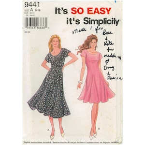 May include: A Simplicity sewing pattern envelope 9441 featuring illustrations of two dresses. One dress is black with a small floral print, and the other is solid pink. Both dresses have short sleeves and a scoop neckline. Handwritten text is present.