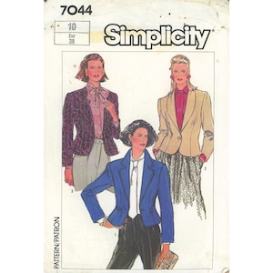 May include: A Simplicity 7044 sewing pattern envelope featuring illustrations of three blazer styles. One blazer is blue, one is tan, and one is a dark patterned fabric. Each is shown with a blouse and trousers or a skirt, with text 7044 and Simplicity.
