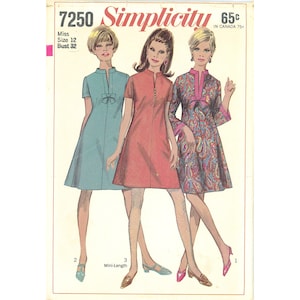 May include: A Simplicity sewing pattern envelope 7250 for a dress in Miss Size 12, Bust 32. The illustration shows three variations of a short-sleeved dress with a stand collar, including a solid teal, a solid red, and a multi-colored paisley print.