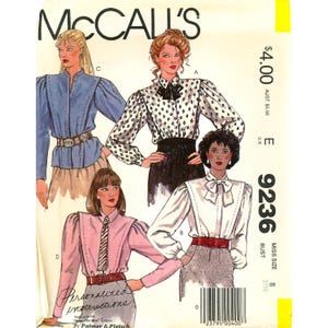 May include: A McCall's 9236 sewing pattern envelope featuring illustrations of four different blouse styles with long sleeves, shoulder detailing, and various necklines including collars and bows, with text including the pattern number 9236.
