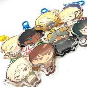 May include: A collection of anime-style character keychains. Each keychain features a unique character design with vibrant colors and attached with a colored clasp. The keychains are made of clear acrylic material.