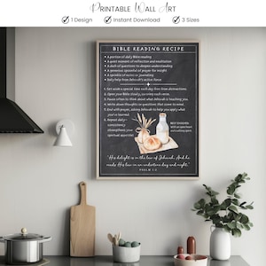Può includere: Stampa artistica da parete incorniciata con un design a lavagna, che mostra la "Ricetta della lettura della Bibbia". La stampa include un'illustrazione ad acquerello di pane, latte e grano. La parte superiore della stampa recita "Printable Wall Art."