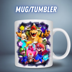 May include: White ceramic mug featuring a colorful graphic of video game characters, including Mario, Luigi, and Bowser, with the text "MUG/TUMBLER" in a blue font. The mug has a white handle and a glossy finish.