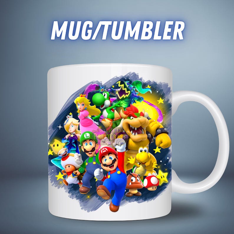 May include: White ceramic mug featuring a colorful illustration of various characters from the Super Mario video game series. The mug has a white handle and the text "MUG/TUMBLER" in a blue font.