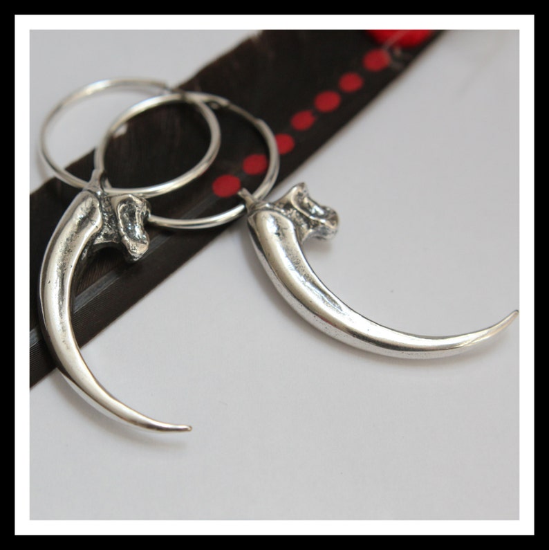 These beautiful eagle talon earrings are life size casts of an American Bald eagle claw. Every minute detail has been captured in mirror polished sterling silver. The overall length from top to bottom is 1-7/8" and 2-3/8" around the curve.