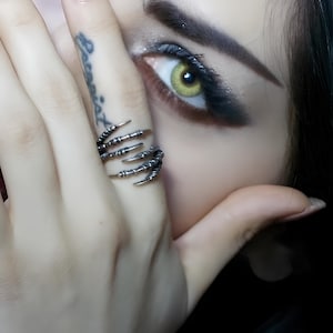 Anel duplo com garras de corvo, em prata de lei maciça.