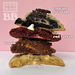 May include: A stack of four cookies, from bottom to top: blondie, turtle, red velvet, and cookies 'n' cream.
