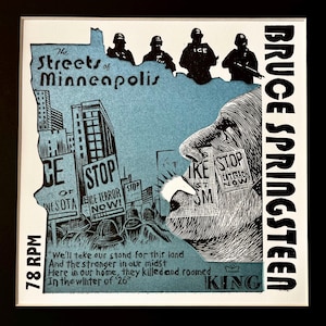 May include: A black and white graphic art print featuring the text "The Streets of Minneapolis" and "Bruce Springsteen." The image includes silhouettes of figures, protest signs, and a profile of a face. The text "78 RPM" is also visible.