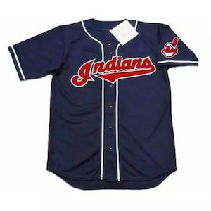 May include: A navy blue baseball jersey with white piping and the word "Indians" in red and white lettering. The jersey has a red and white logo of a Native American chief on the right sleeve.