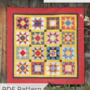 May include: A quilt pattern called "Gingham Girl Stars" by Amy Smart, featuring a red, yellow and blue patchwork design with stars and gingham patterns. The quilt is displayed against a wooden background. The text "Diary of a Quilter.com" is also visible.