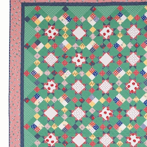 May include: A quilt pattern called "Granny Smith" by Amy Smart, featuring a green, red, white and blue patchwork design with a gingham border.