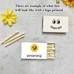 May include: Two white matchboxes with different logos. The first box has a smiley face with the word "pranky" printed below it. The second box has two eyes and the words "GOODY BAG" printed below it.