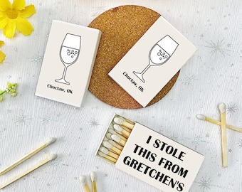 May include: A set of white matchboxes with a black outline of a wine glass and the text "Choctaw, OK". A separate matchbox has the text "I stole this from Gretchen's".