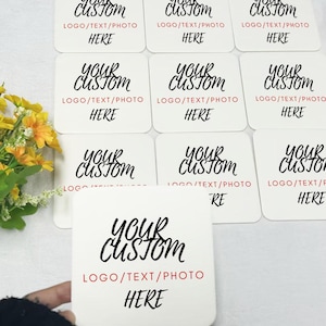 May include: Nine white square coasters with black text that reads "Your Custom" and "Logo/Text/Photo Here".