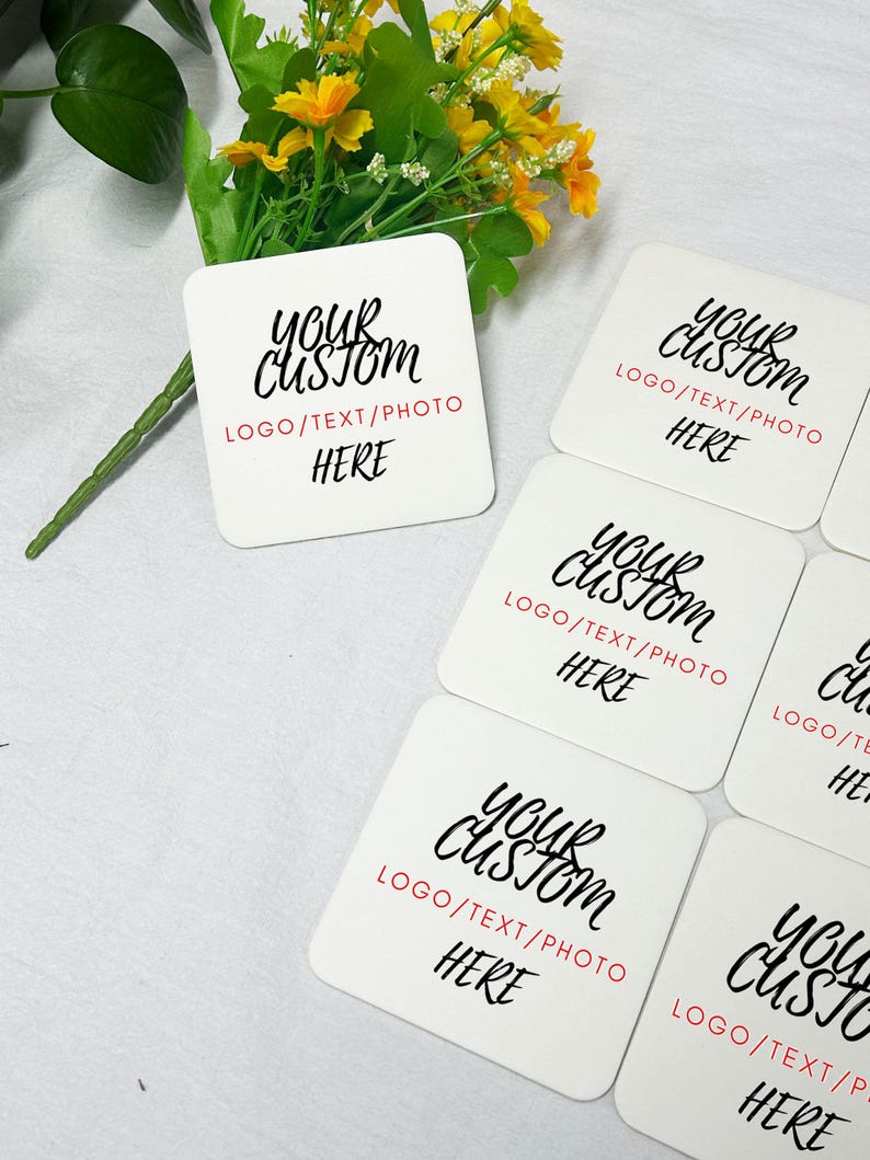 May include: Five white square coasters with black text that reads "Your Custom" and "LOGO/TEXT/PHOTO HERE".