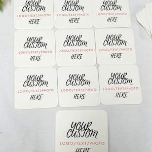 May include: Nine white square coasters with black text that reads "Your Custom" and "LOGO/TEXT/PHOTO HERE".