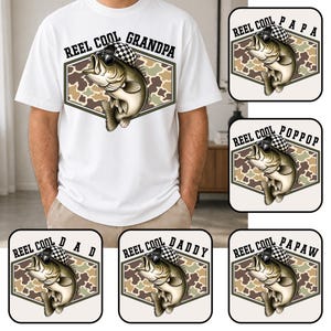 May include: White t-shirt with a graphic of a fish wearing sunglasses and a checkered hat, inside a camouflage hexagon. Text above the fish reads "REEL COOL GRANDPA". Additional graphics with the text "REEL COOL PAPA", "REEL COOL POPPOP", "REEL COOL DAD", "REEL COOL DADDY", and "REEL COOL PAPAW".