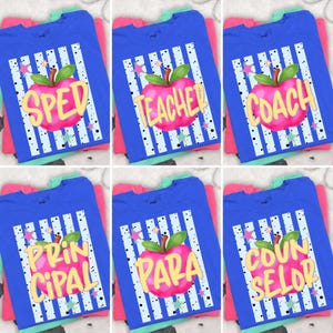 May include: Blue t-shirts with various school-related graphics. Each shirt features a large pink apple with a green leaf and the words "SPED", "TEACHER", "COACH", "PRINCIPAL", "PARA", and "COUNSELOR" in yellow. The design includes white stripes and star accents.