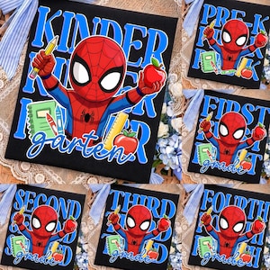 May include: A black rectangular sign featuring a cartoon Spider-Man character holding a yellow pencil and a red apple. The design includes school supplies like a green notebook, a red crayon, and a yellow ruler, with text indicating grade levels.