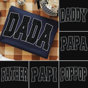 May include: Navy blue sweatshirt with the word "DADA" in large, bold, black letters with a leopard print and checkered pattern. Additional images show the words "DADDY", "PAPA", "FATHER", "PAPI", and "POPPOP" in similar styles.