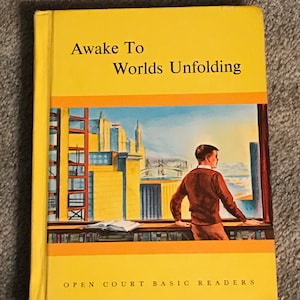May include: A hardcover book titled "Awake To Worlds Unfolding" with a yellow cover and a cityscape illustration. The book features a boy looking out a window at a city. The text "Open Court Basic Readers" is at the bottom.