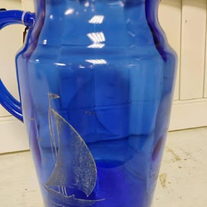 Vintage Hazel Atlas Cobalt Blue Glass Pitcher. features a Nautical theme with Sailboat.