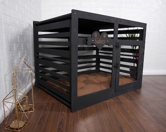 May include: A black wooden pet crate with horizontal slats and a hinged door. A heart-shaped plaque is attached to the front, featuring the name Sidney and two paw print icons. Inside the crate is a brown tufted cushion for comfort and rest.